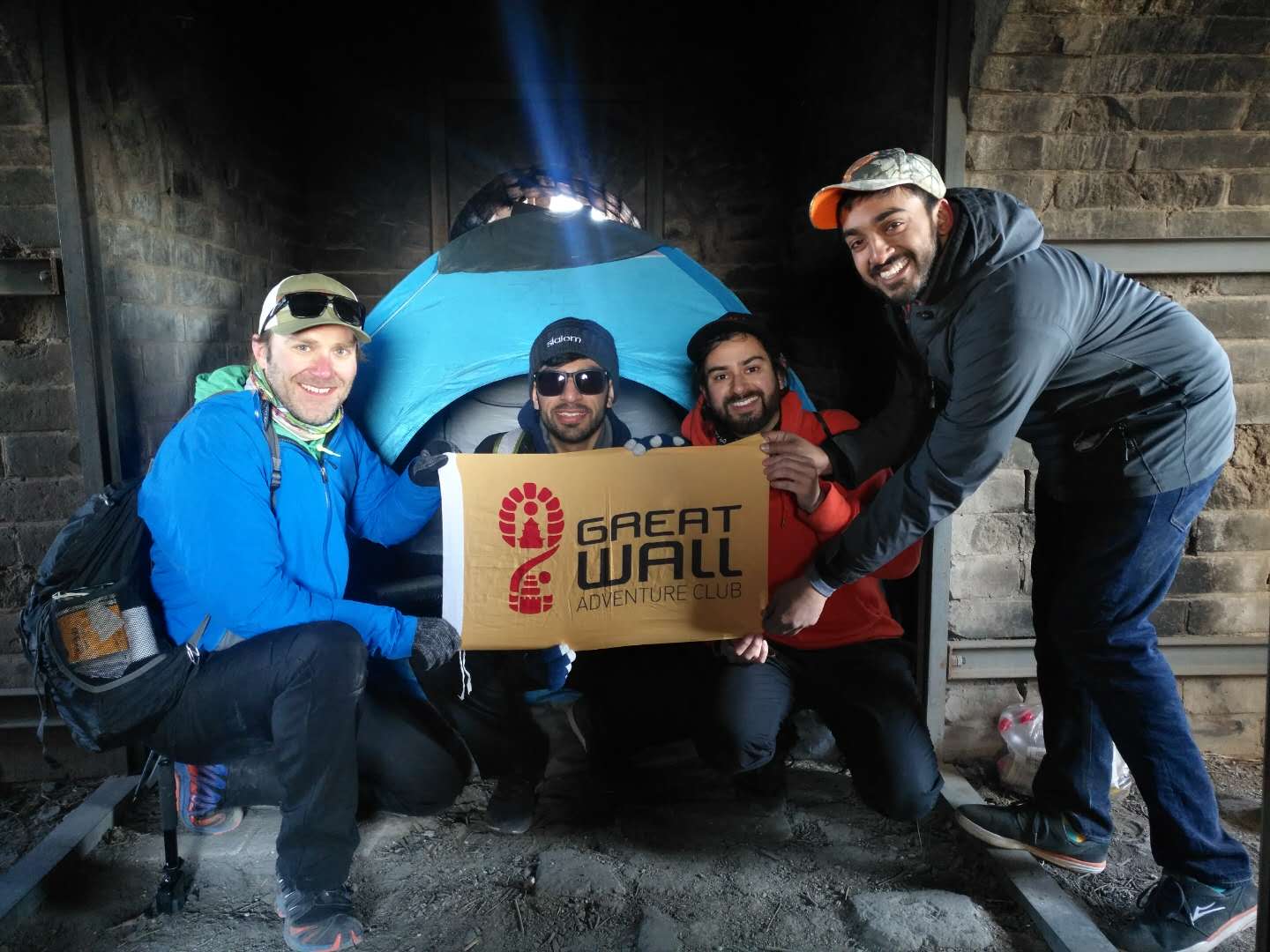 Great Wall Adventure Club guests with a tent inside a Great Wall watchtower